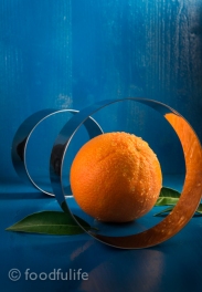 Orange with pastry cutters on blue background