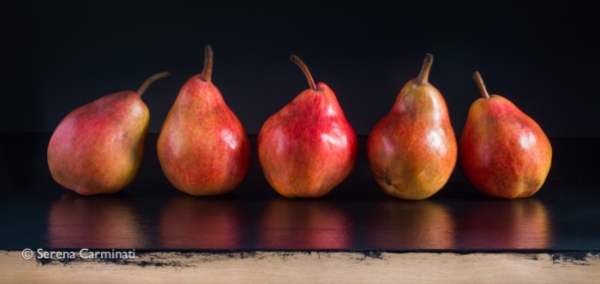 Red pears on black background