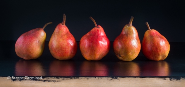 Red pears on black background